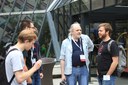 RIOTers discuss in front of the IETF 96 building